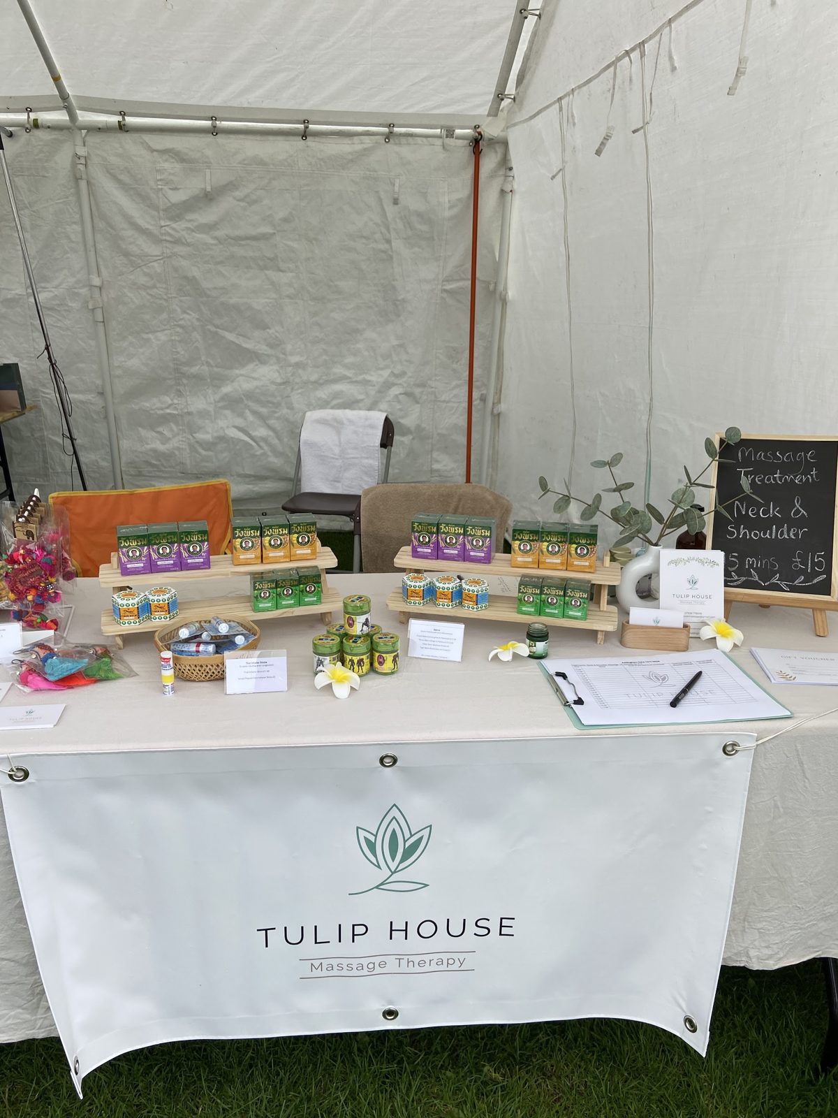 The Tulip House Massage Therapy stall and banner inside a marquee